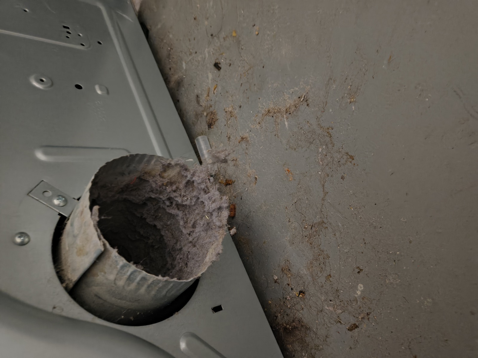 Clogged dryer exhaust vent with lint buildup before cleaning