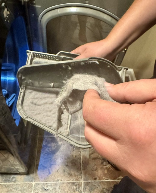 Dryer lint trap cleaning during professional vent service in Kansas City